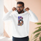 White hoodie worn by a bearded male model adjusting the hood, close-up on the B Brooklyn Bridge sunset skyline graphic.