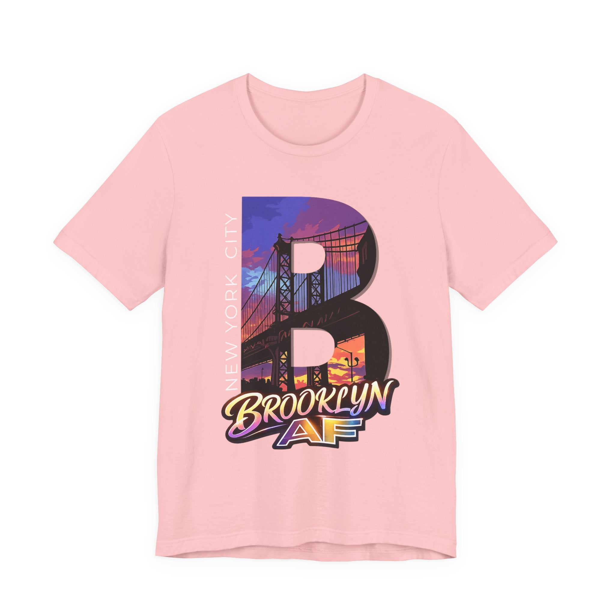 Pink t-shirt, flat lay front view, with a bold B and a purple-orange Brooklyn Bridge sunset skyline graphic.