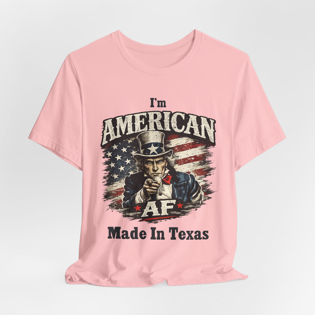 Pink tee laid flat with a relaxed drape, showing Uncle Sam graphic and 'Made In Texas' text