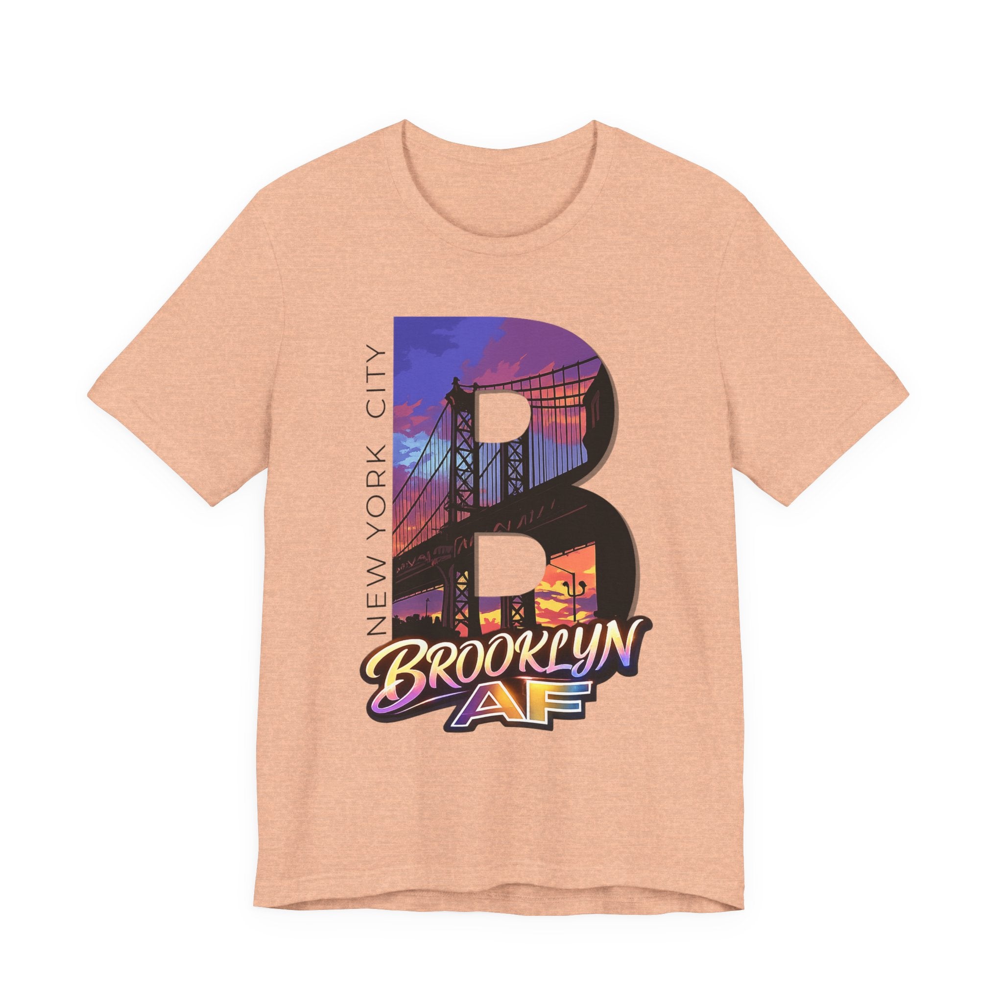 Heather peach t-shirt, flat lay, with a bold oversized "B" featuring a Brooklyn Bridge sunset skyline graphic.