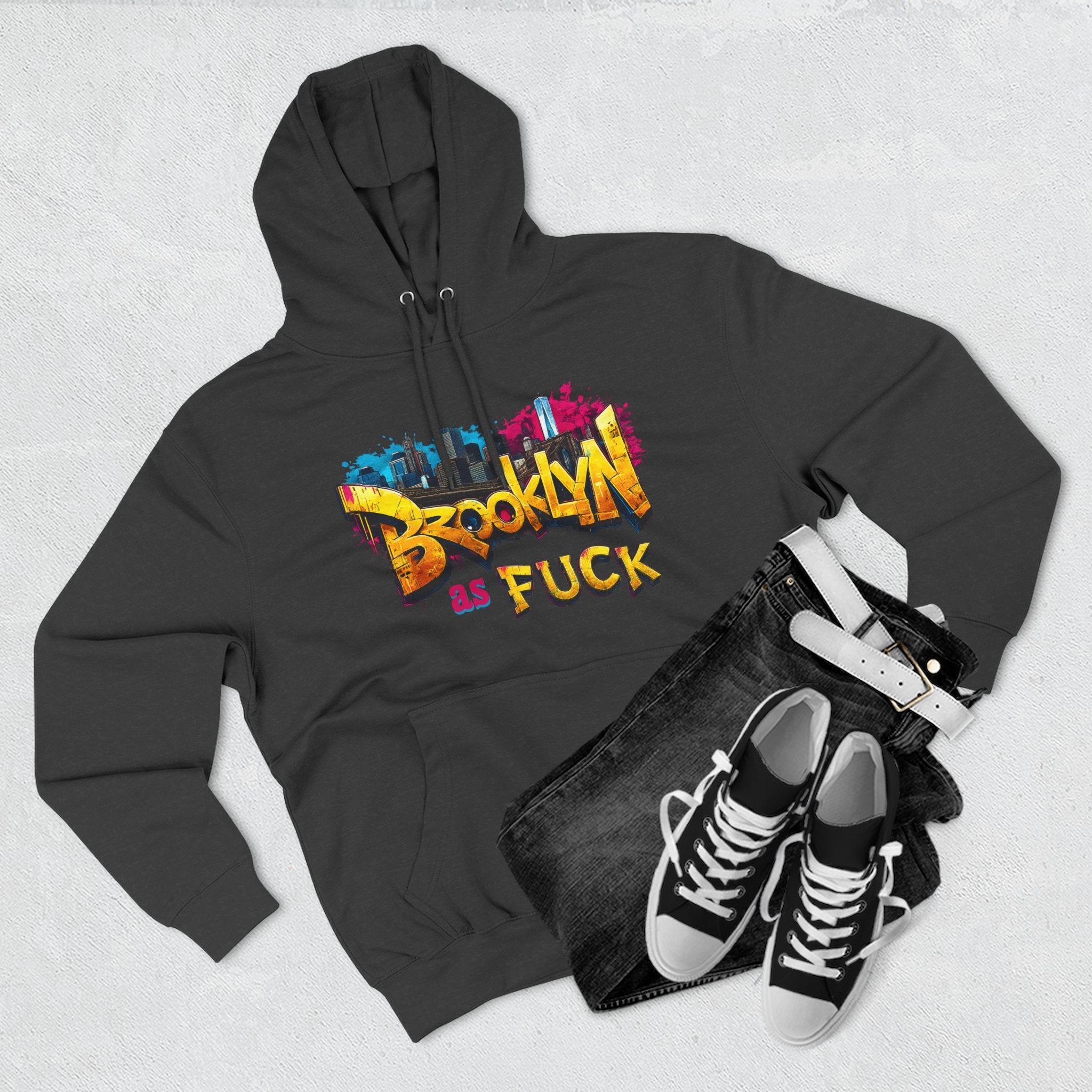 Charcoal heather hoodie styled flat lay with jeans, belt, and sneakers, graffiti Brooklyn As Fuck NYC skyline print.