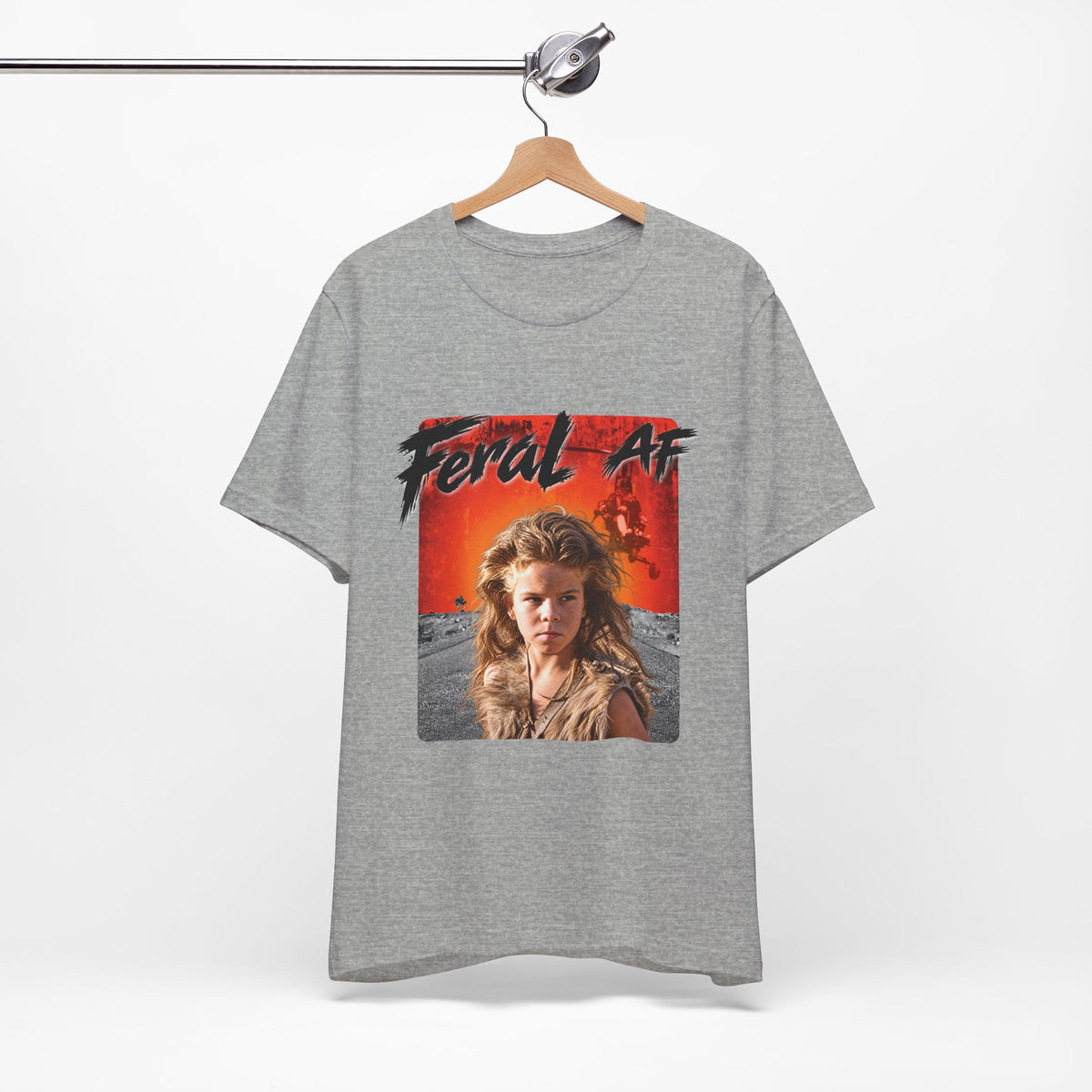 Athletic Heather Feral AF tee on a wooden hanger against a pale wall, front print facing forward