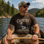 Man in a canoe on a mountain river wearing the Dark Chocolate Country As Fuck tee