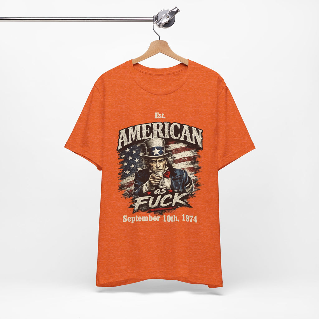 Heather orange t-shirt hanging on a wooden rack, showing Uncle Sam graphic with a customizable date line
