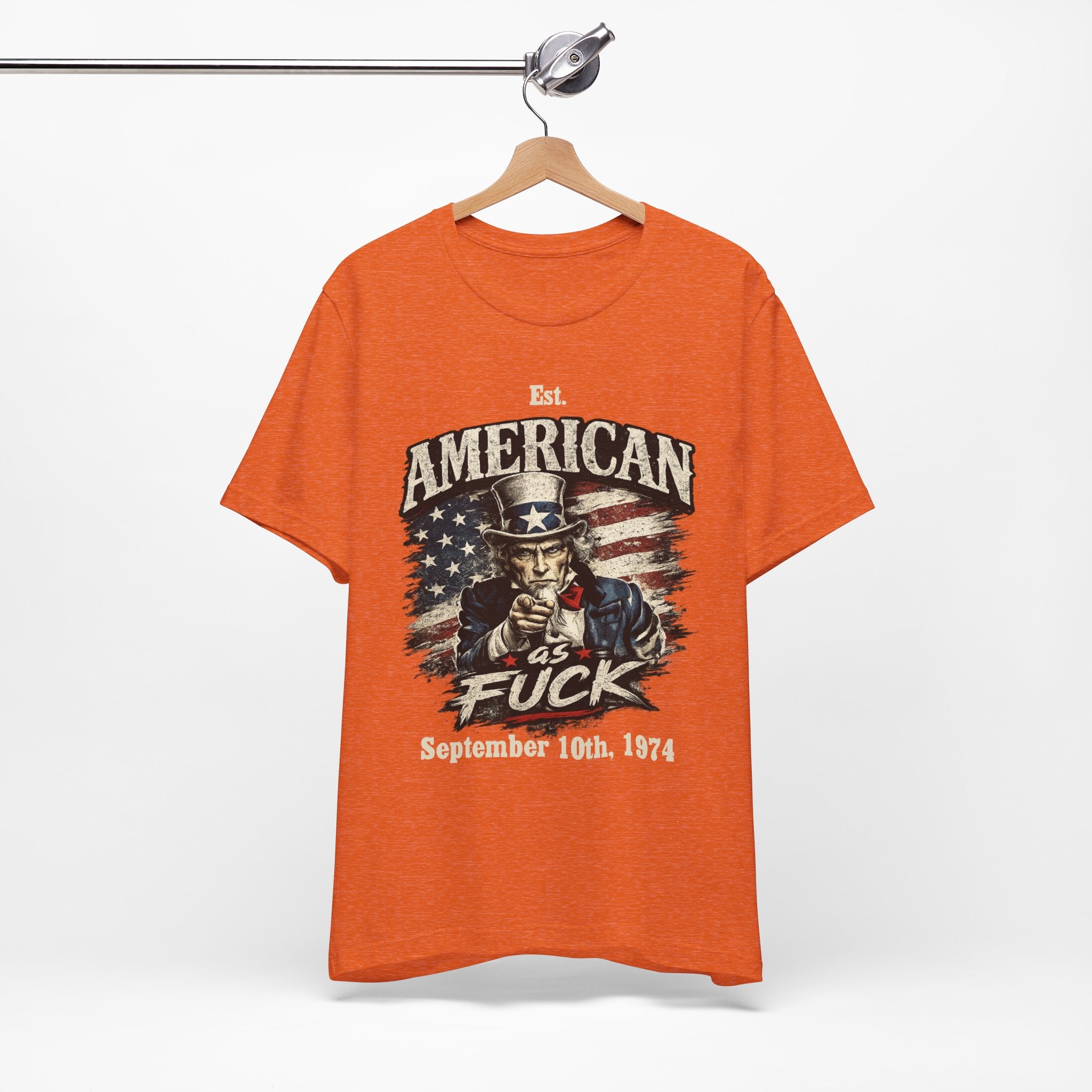 Heather orange t-shirt hanging on a wooden rack, showing Uncle Sam graphic with a customizable date line