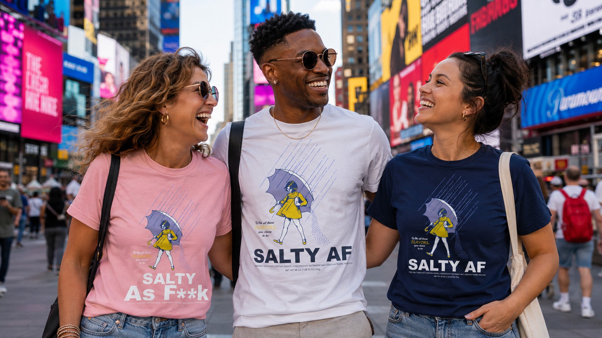 Three friends wearing t-shirts with a graphic of a character and the text 'Salty AF' in a busy urban setting.