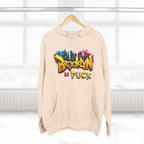 Oatmeal Heather Brooklyn As Fuck graffiti hoodie on a wooden hanger by a window