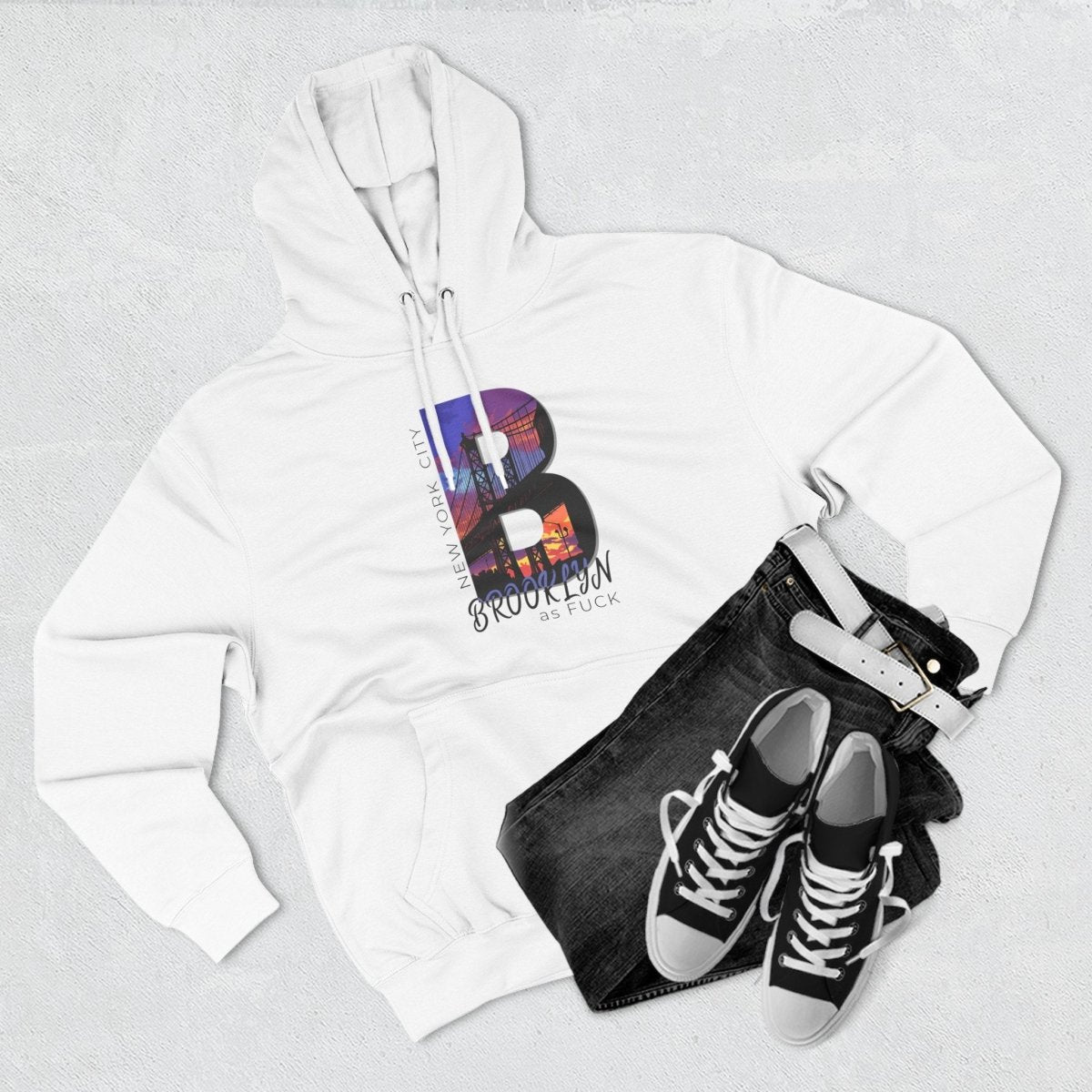 White Brooklyn As Fuck hoodie styled flat with black high-top sneakers