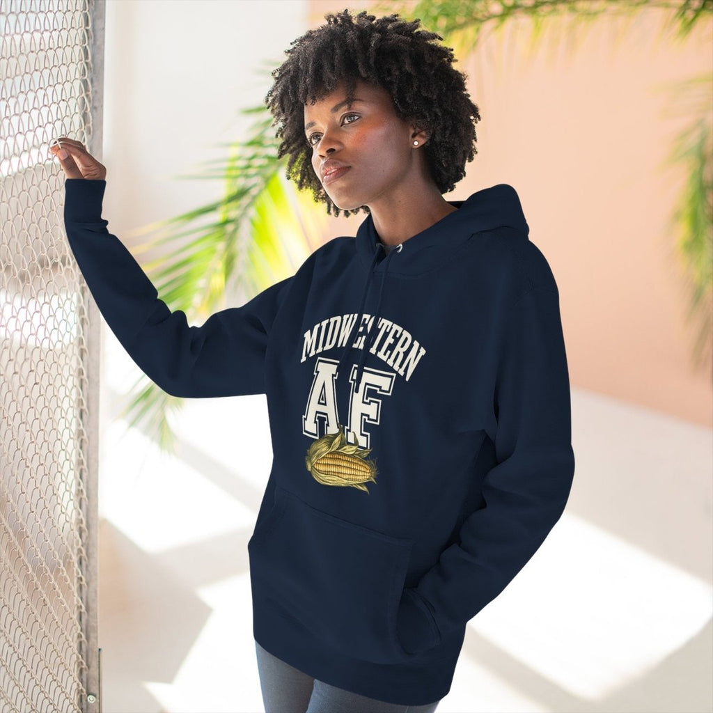 Woman at a sunlit window in the Navy Midwestern AF corn hoodie