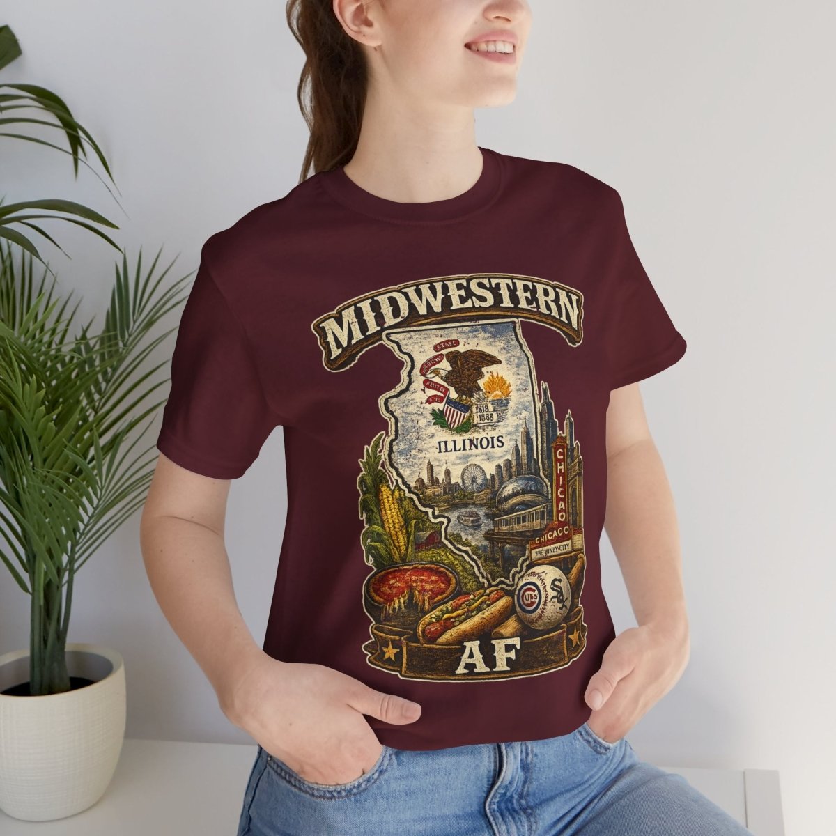 Woman beside a potted plant wearing the Maroon Illinois Midwestern AF tee