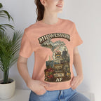 Woman beside a potted plant wearing the Heather Peach Michigan Midwestern AF tee