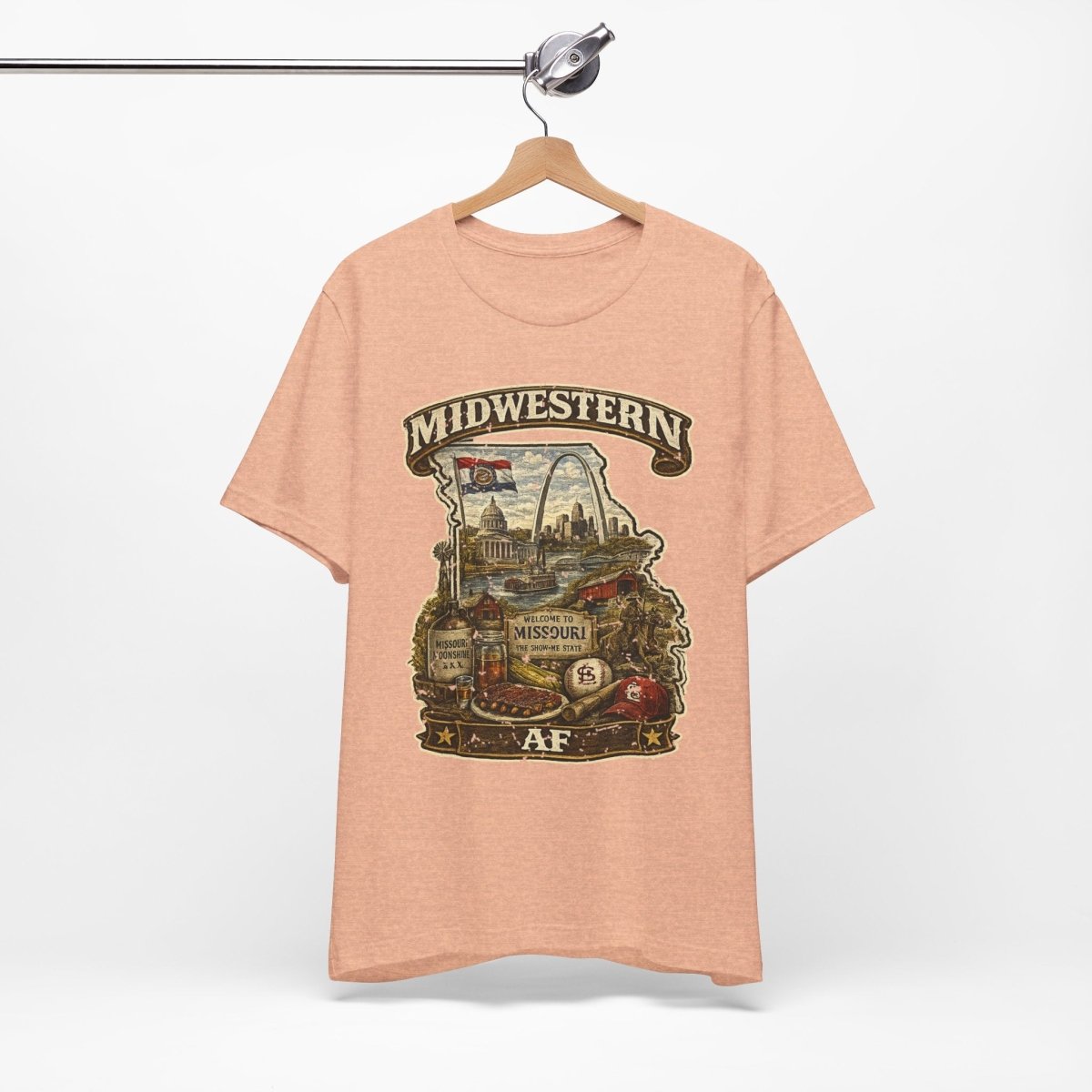 Heather Peach Missouri Midwestern AF tee on a metal hanger against a white wall