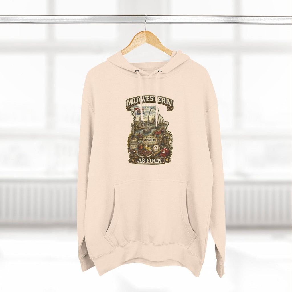 Oatmeal Heather Missouri Midwestern As Fuck hoodie on a wooden hanger by a window
