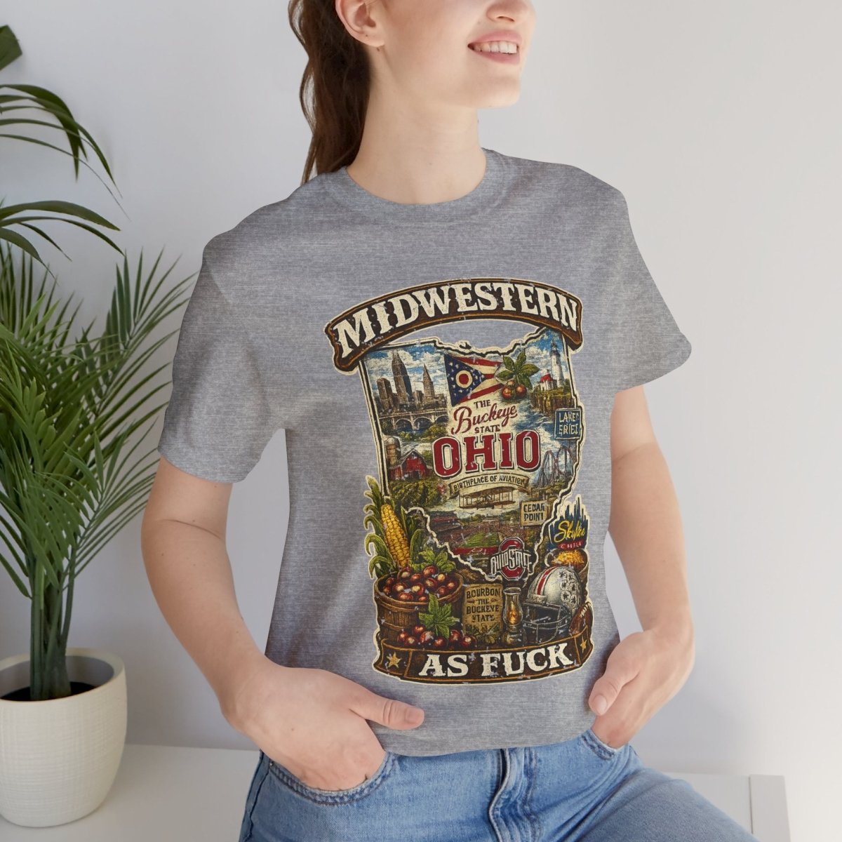 Woman by a plant in the Athletic Heather Ohio Midwestern As Fuck tee